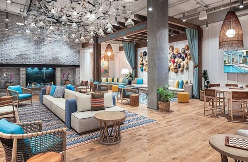 East Village Hotel | Unwind in a Tropical-Themed Room with Festive Vibes