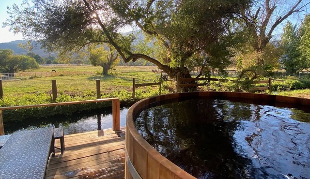Mountain View: River flowing past hot tub overlooking horse meadows
