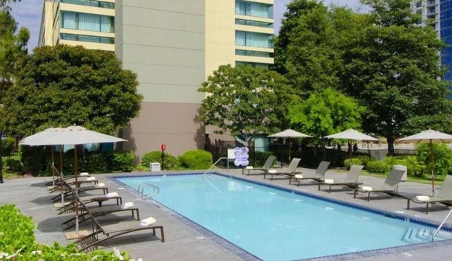 OC Stay by the Airport | Pool + On-Site Dining