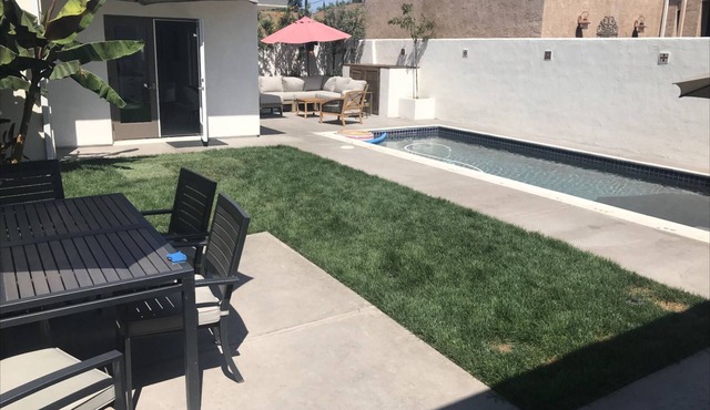 Spanish bungalow with pool, built in bbq, and outdoor seating areas.